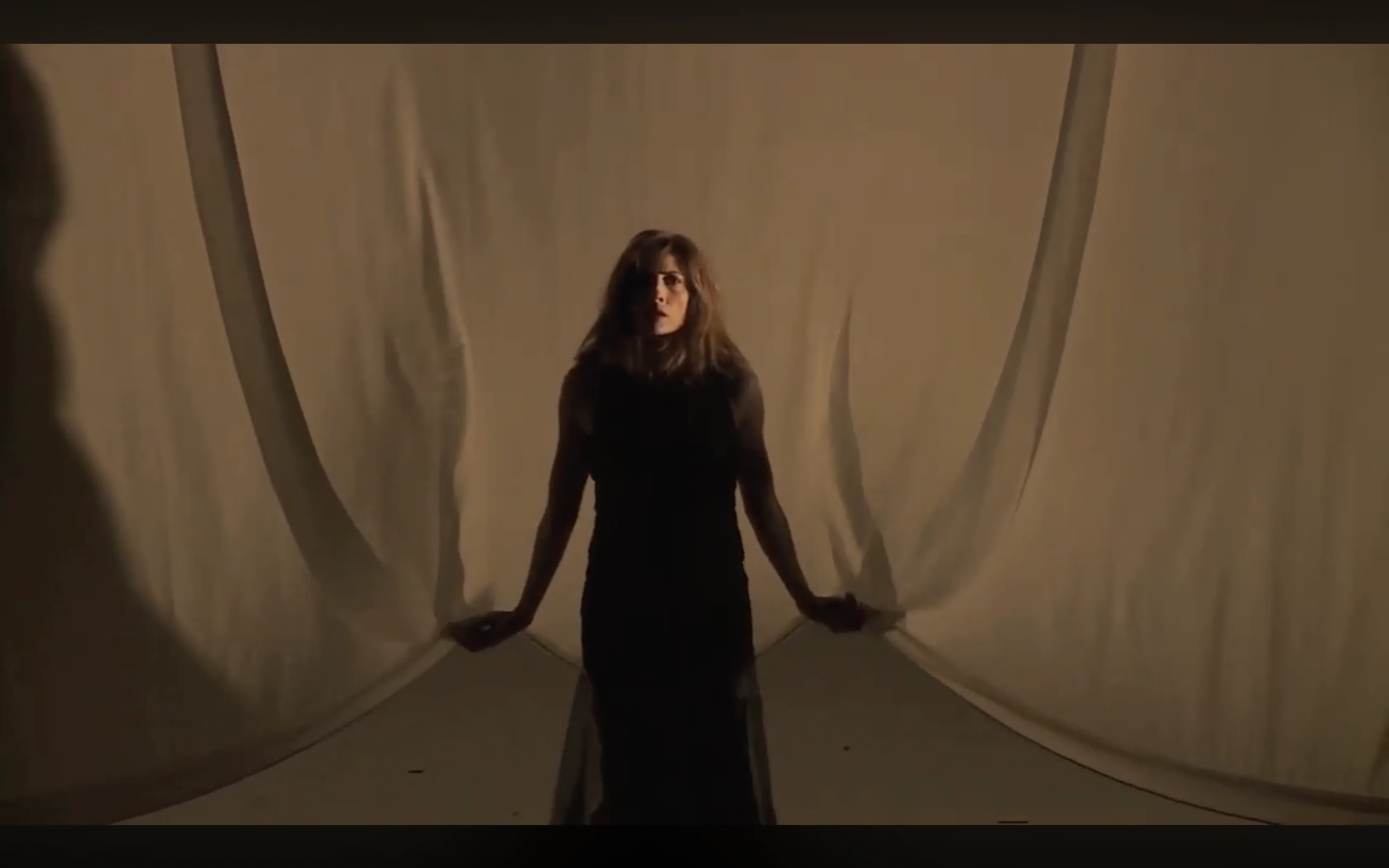 The Step-Daughter emerging through the curtain threshold